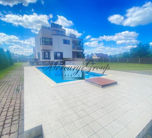 Three-story house with a pool in Catlakalns